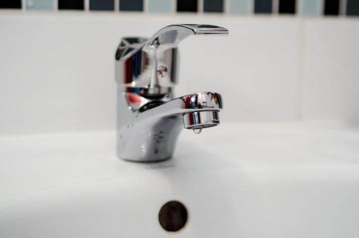 plumber unclogging sink bathroom